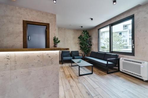 a living room with a couch and a tv at Hotel Vladimir in Budva