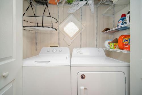 uma cozinha com um fogão branco e uma máquina de lavar e secar roupa em Beautiful Historic Downtown Charleston Home em Charleston