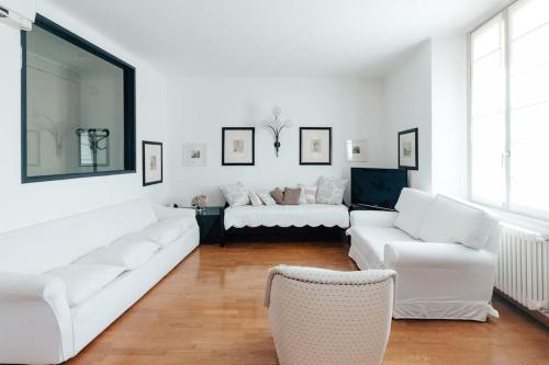een woonkamer met witte meubels en een bank bij La casa di Isa in Lecco