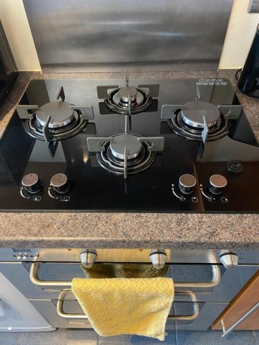 a stove top with four burners on top of it at The OVO Hydro Penthouse With Free Parking in Glasgow