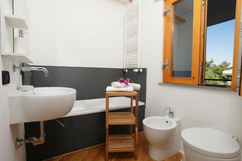 a bathroom with a sink and a toilet at Pizzo Cane House camera con bagno e piscina in Altavilla Milicia