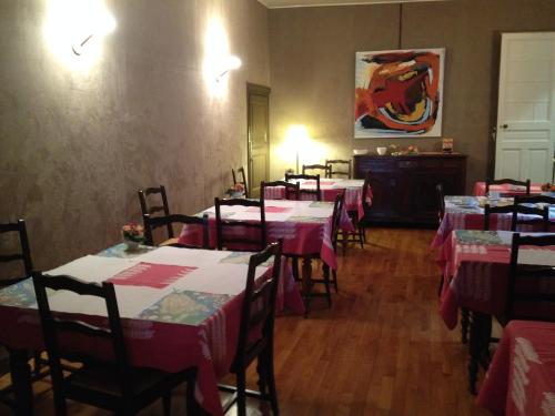 a dining room with tables and chairs with pink tablecloths at Hotel Du Nord in Besançon