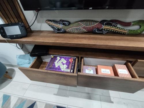 a wooden shelf with books on a table at Epiqe Manuel Olguin 600 in Lima