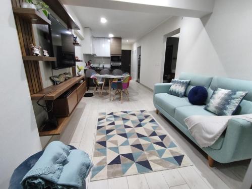 a living room with a couch and a table at Epiqe Manuel Olguin 600 in Lima