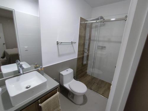 a bathroom with a toilet and a sink and a shower at Epiqe Manuel Olguin 600 in Lima