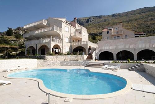 a large swimming pool in front of a building at Apartments with a swimming pool Soline, Dubrovnik - 4762 in Mlini