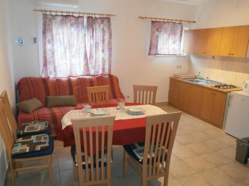 a kitchen and dining room with a table and chairs at Apartment Maja in Vodice