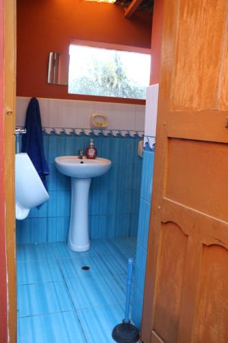 a small bathroom with a sink and a sink at LOVELAND AMANTANI LODGE - Un lugar encantado in Amantani
