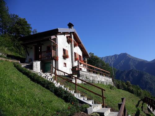 a house on a hill with stairs leading up to it at Casa all'Alpe Gaggetto B & B in Anzino