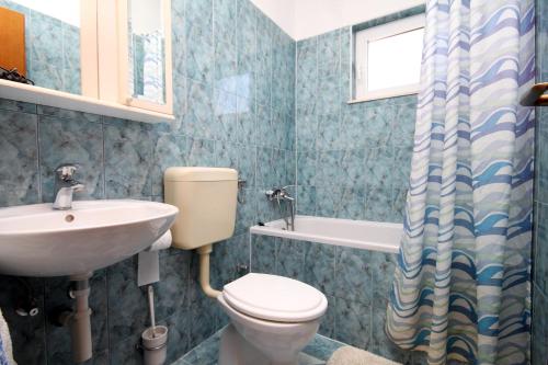 a bathroom with a toilet and a sink at Apartments by the sea Businci, Ciovo - 4668 in Trogir