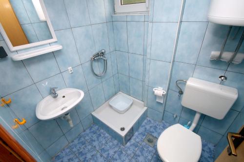 a blue bathroom with a sink and a toilet at Apartments with a parking space Podaca, Makarska - 4747 in Podaca