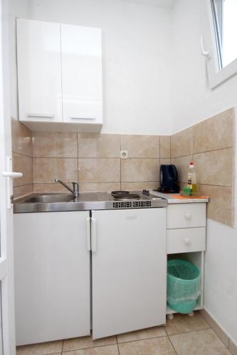 a kitchen with white cabinets and a sink at Apartments with a parking space Podaca, Makarska - 4747 in Podaca