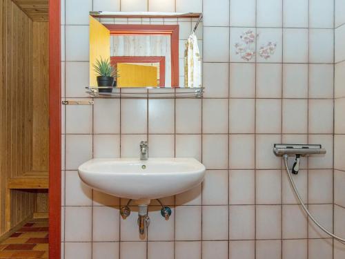 a bathroom with a sink and a mirror at Holiday Home Strandskadevej in Ørsted