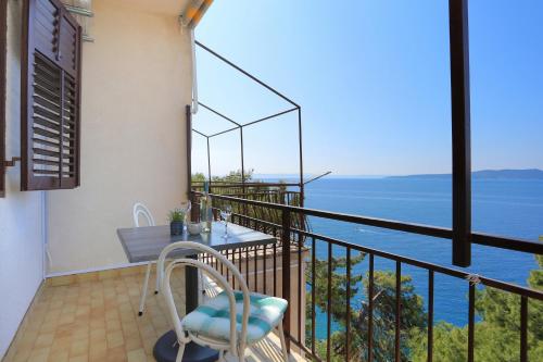 a balcony with a table and a view of the ocean at Apartments by the sea Brela, Makarska - 2718 in Brela