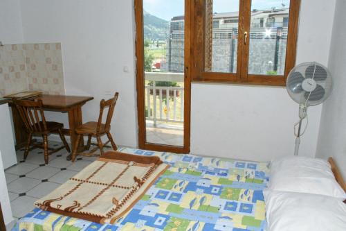 a bedroom with a bed and a desk and a fan at Studio Omis 2757a in Omiš