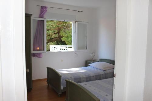 a bedroom with two beds and a window at Apartments by the sea Mimice, Omis - 2774 in Mimice