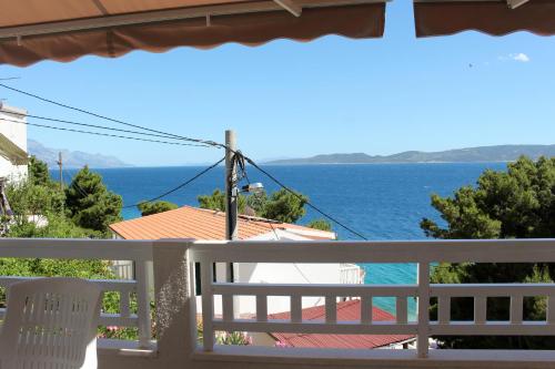 a view of the ocean from the balcony of a house at Apartments by the sea Mimice, Omis - 2774 in Mimice