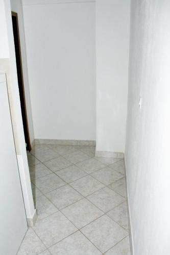 a hallway with a tile floor and white walls at Apartments by the sea Mimice, Omis - 2774 in Mimice