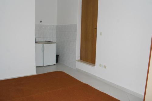 a room with a kitchen with a sink and a counter at Studio Duce 2746b in Duće