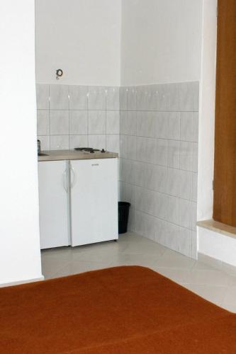 a kitchen with a counter and a sink in a room at Apartments and rooms by the sea Duce, Omis - 2746 in Duće