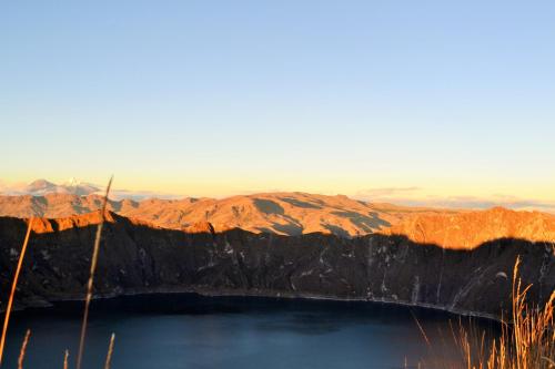 a view of a lake with mountains in the background at Hotel PrincesaToa in Quilotoa