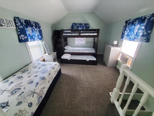 a bedroom with two beds and a bunk bed at Sea Latch Inn in York Beach