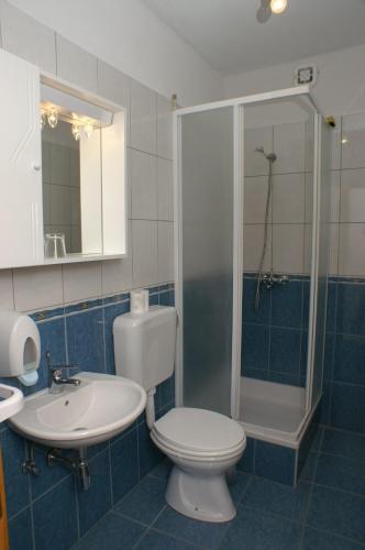 a bathroom with a toilet and a sink and a shower at Apartments by the sea Milna, Hvar - 3074 in Hvar
