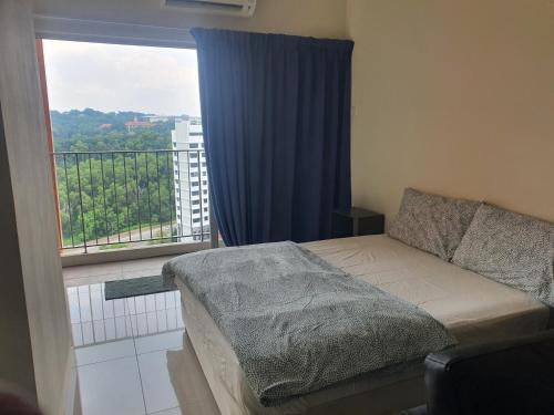 a bedroom with a bed and a large window at Lovely studio condo with balcony & pool @ Suria Jelutong in Shah Alam