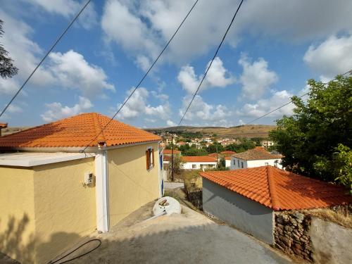 a view of a house with an orange roof at Old House Villa Moudros- Kaminia Lemnos Λήμνοs in Ayía Sofía