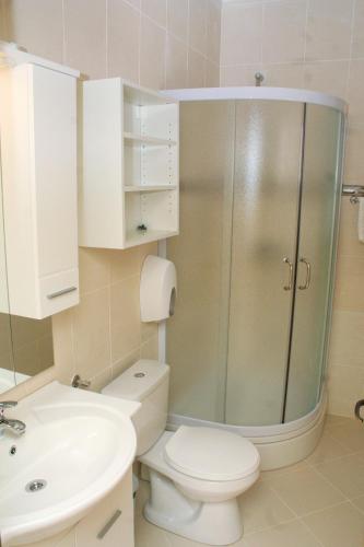 a bathroom with a shower and a toilet and a sink at Apartment Rogoznica 3097a in Rogoznica