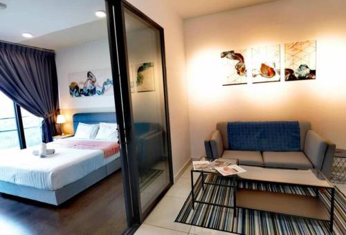 a bedroom with a bed and a couch and a mirror at 1719 Almas Suites Muji Studio100mbpsNetflix By STAY in Nusajaya