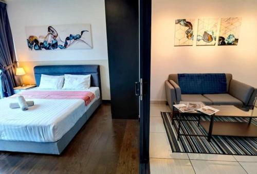 a bedroom with a bed and a couch and a table at 1719 Almas Suites Muji Studio100mbpsNetflix By STAY in Nusajaya