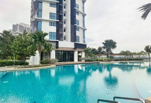 a large swimming pool in front of a building at 1719 Almas Suites Muji Studio100mbpsNetflix By STAY in Nusajaya
