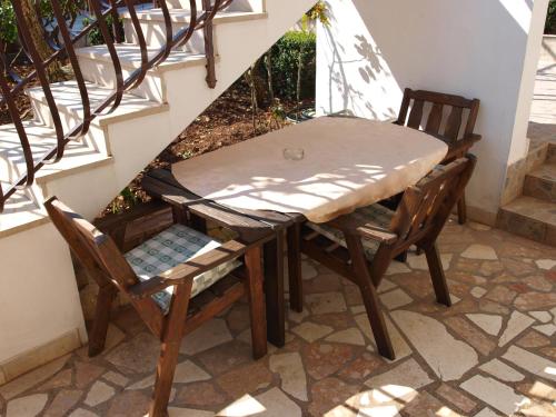a table and two chairs sitting on a patio at Apartments with a parking space Businci, Ciovo - 4667 in Trogir