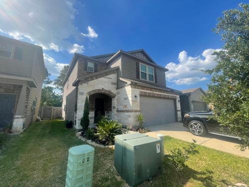 a house with a car parked in front of it at N-E-G House - near DAVID WAYNE HOOKS Airport in Houston