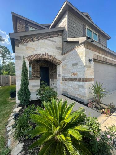 a house with a white garage at N-E-G House - near DAVID WAYNE HOOKS Airport in Houston