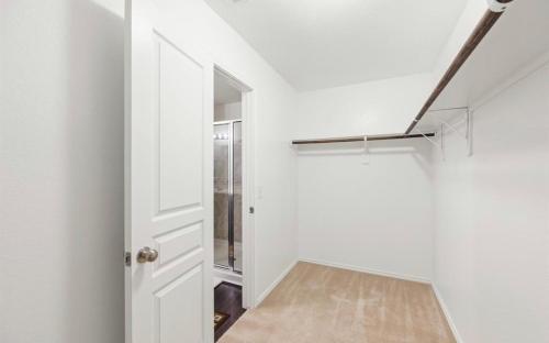 a hallway with a white door and a stairwell at N-E-G House - near DAVID WAYNE HOOKS Airport in Houston