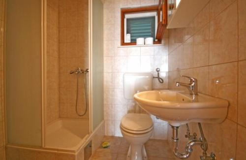 a bathroom with a sink and a toilet and a shower at Holiday house with a parking space Bol, Brac - 4661 in Bol