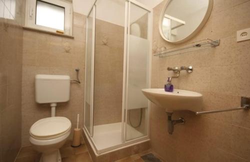 a bathroom with a toilet and a shower and a sink at Apartments with a parking space Bol, Brac - 4659 in Bol