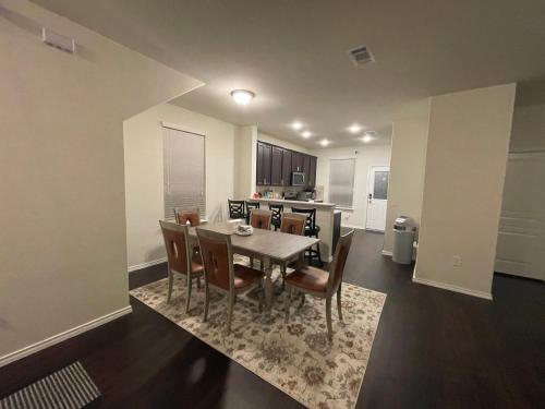 a dining room and kitchen with a table and chairs at N-E-G House - near DAVID WAYNE HOOKS Airport in Houston