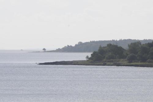 a large body of water with trees in the distance at STF Baskemölla Hostel in Simrishamn