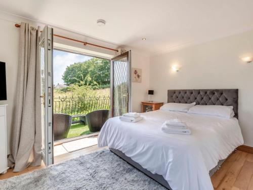 a bedroom with a bed and a sliding glass door at Freshwinds in Market Drayton