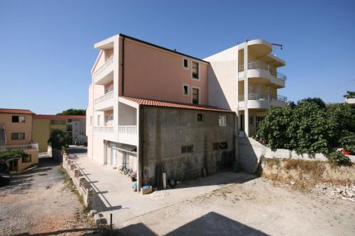 a building in front of a building at Apartments with a parking space Duce, Omis - 4650 in Duće