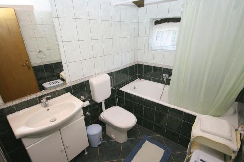 ein Badezimmer mit einem Waschbecken, einem WC und einer Badewanne in der Unterkunft Apartments by the sea Cove Jagodna - Brusje, Hvar - 4619 in Brusje