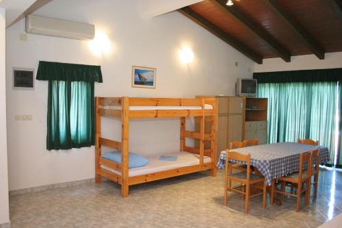 a bedroom with a bunk bed and a table at Apartments by the sea Cove Jagodna - Brusje, Hvar - 4619 in Brusje