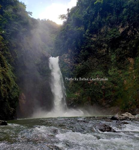 a waterfall in the middle of a river at Batad Countryside in Banaue