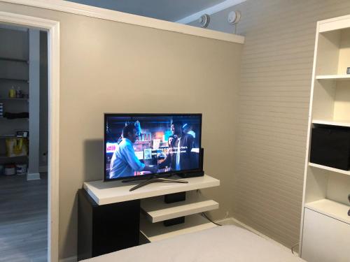 a living room with a television in a room at Condo 103 in Miami Beach