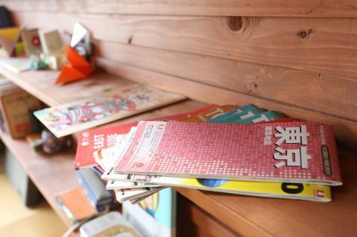 a stack of books sitting on top of a table at GrapeHouse Koenji in Tokyo