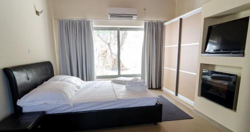 a bedroom with a bed and a large window at VergaView Luxury House in Kalamata
