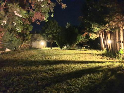 a yard at night with lights on the grass at HOUSE SUITES DOMAINE in Rizómilos